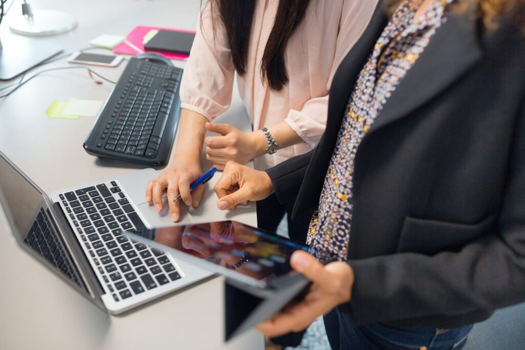 Architect and project manager working on digital tablet in office