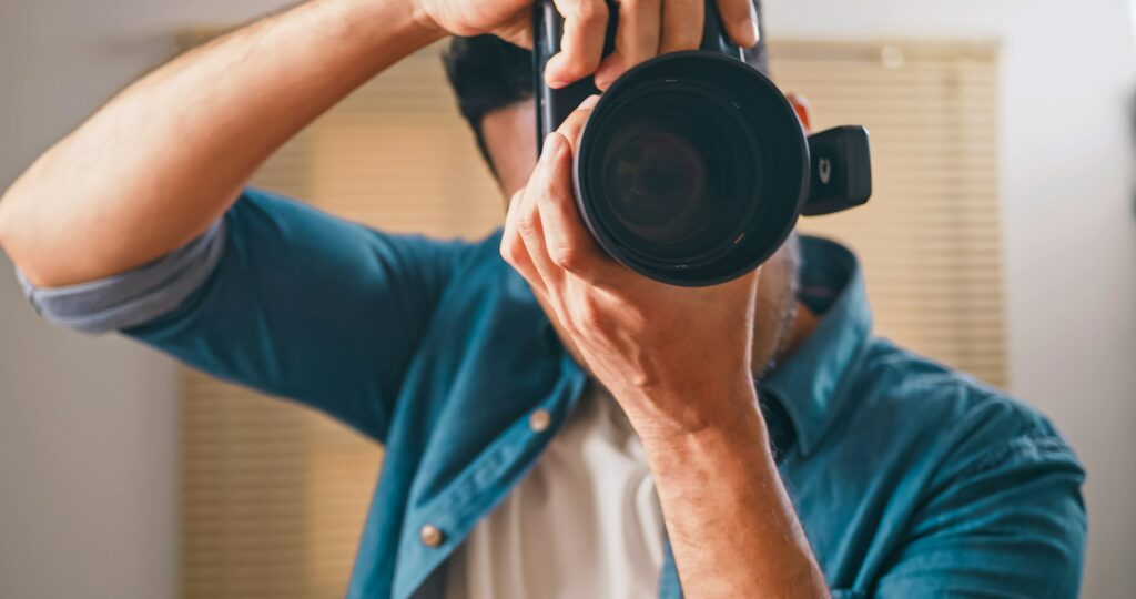 Professional male photographer working in studio.